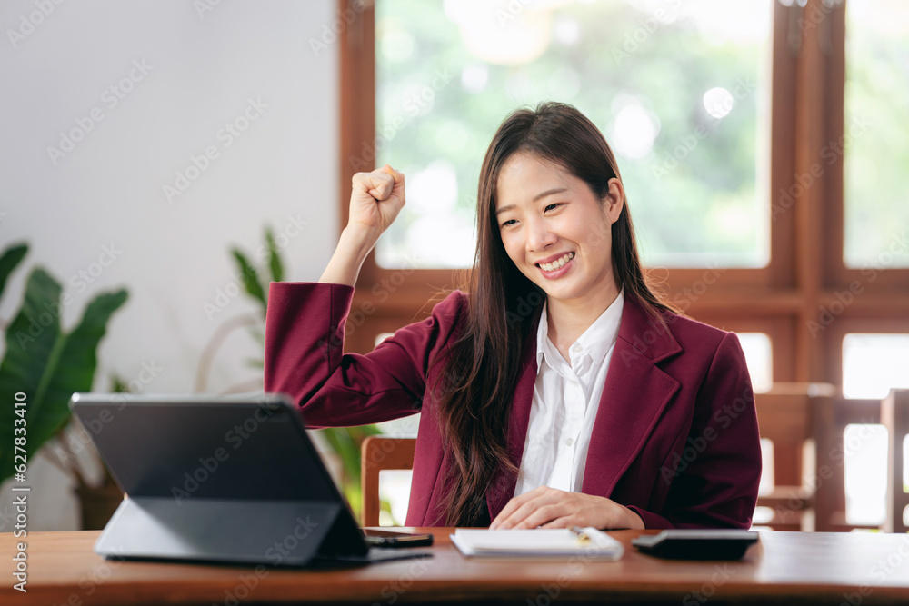 Accounting business concept, Accountant woman excited and raising fist to celebrate achievement while working on laptop about investment with business planning finance Accounting business concept, Accountant woman excited and raising fist to celebrate achievement while working on laptop about investment with business planning finance