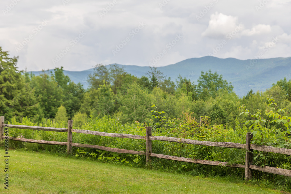 landscape of mountains with wooden fence and trees