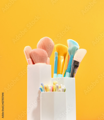 A set of variety colorful brushes for spectacular professional stylish makeup and cotton buds. Beauty and skincare products.