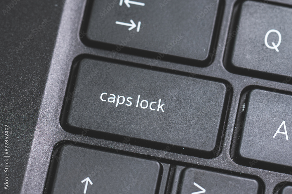 Caps Lock key on a black laptop keyboard. Caps Lock key on a black laptop keyboard.