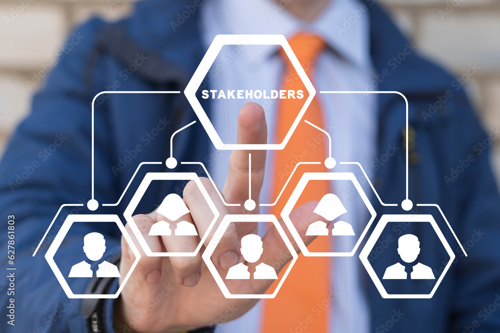 Businessman using virtual touchscreen presses word: STAKEHOLDERS. Concept of business finance stakeholder investment management. Different stakeholders contact collaboration for company organization.