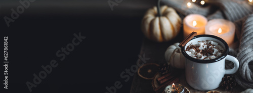 Autumn cozy home composition with hot chocolate with marshmallow and candles. Aromatherapy on a grey fall morning, atmosphere of cosiness and relax. Wooden background close up banner copy space