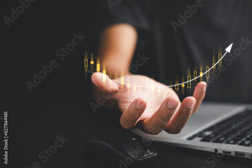 The power of knowledge at your fingertips, with a trader or investor utilizing a palm-held device to analyze charts, signals, and trends in the stock market, maximizing their investment opportunities.
