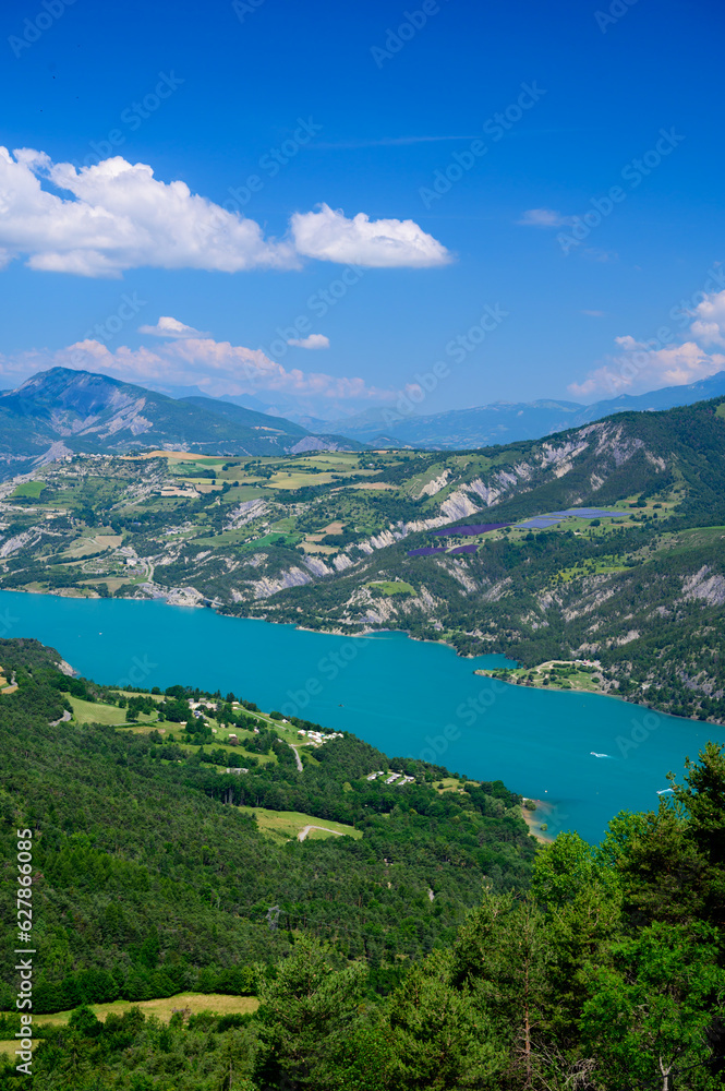 Aerial view on blue Lake of Serre-Poncon, reservoir border between Hautes-Alpes and Alpes-de-Haute Provence   departments, one of largest in Western Europe