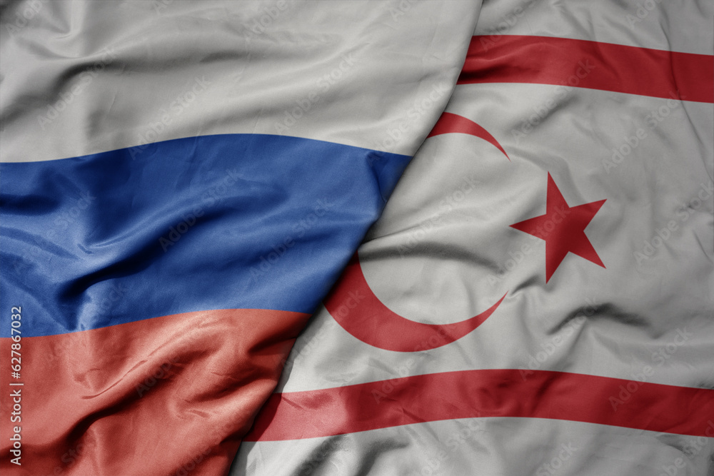 Fototapeta premium big waving realistic national colorful flag of russia and national flag of northern cyprus .