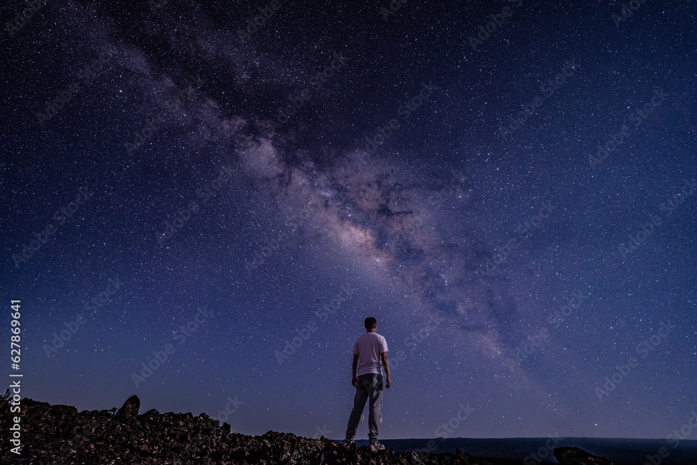 Men / boy on the Milky Way. Stargazing at  Mauna Loa Observatory Road, Big Island Hawaii. Starry night sky,  galaxy astrophotography. 