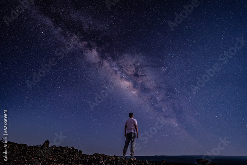 Men / boy on the Milky Way. Stargazing at Mauna Loa Observatory Road, Big Island Hawaii. Starry night sky, galaxy astrophotography. 