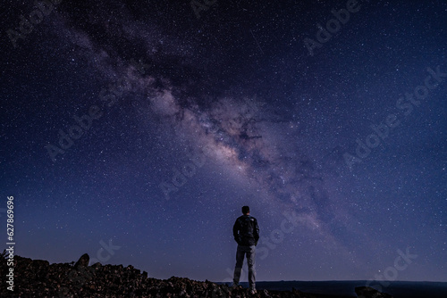 Silhouette of Men / boy on the Milky Way. Stargazing at Mauna Loa Observatory Road, Big Island Hawaii. Starry night sky, galaxy astrophotography. 