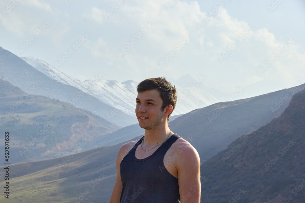 teenager against the backdrop of the mountains after climbing portrait of a cheerful boy in the highlands teenager against the backdrop of the mountains after climbing portrait of a cheerful boy in the highlands