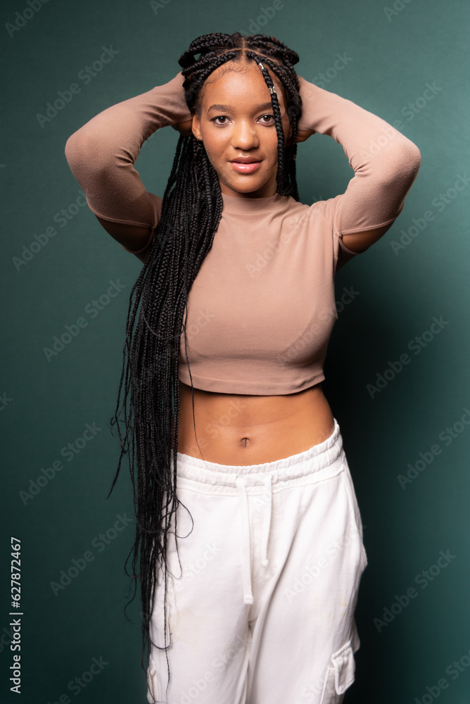 Beautiful young woman, standing, messing with her long hair. Beautiful young woman, standing, messing with her long hair.