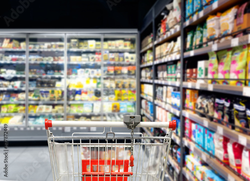 Choosing food from shelf in supermarket,vegetables in grocery section,empty groc Fototapet
