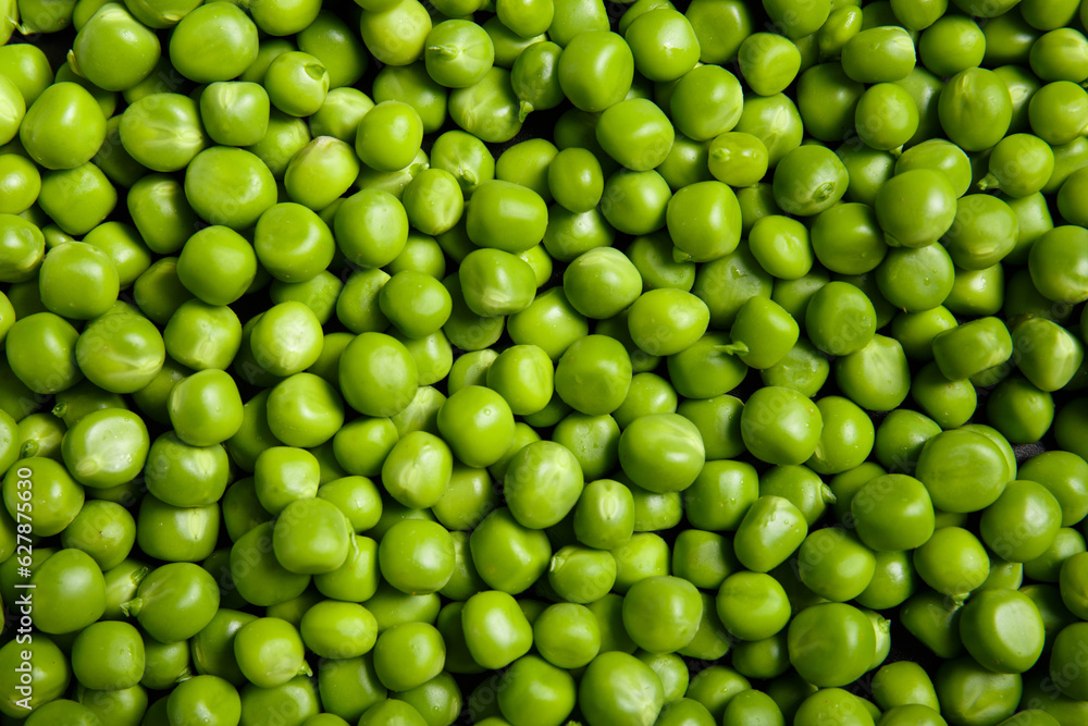 Background of fresh organic sweet green peas, pea grains close-up, top view.