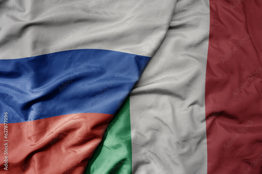big waving realistic national colorful flag of russia and national flag of italy .