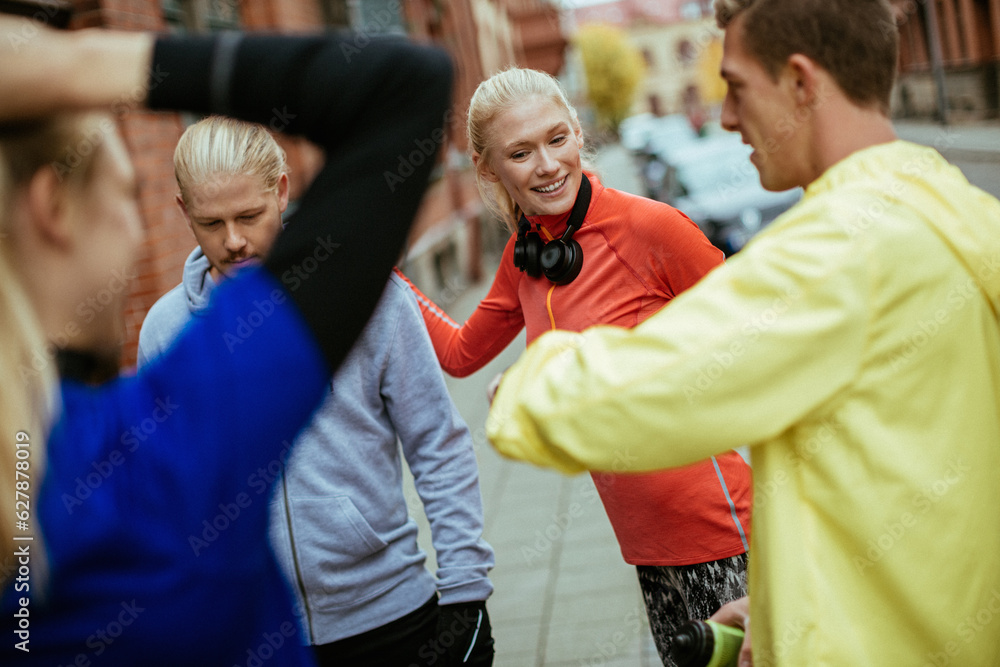 Young people stretching and getting ready to go jogging in the city