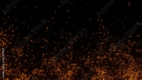 Explosion of light fire sparks on black. Orange particles that look like sparks from a campfire