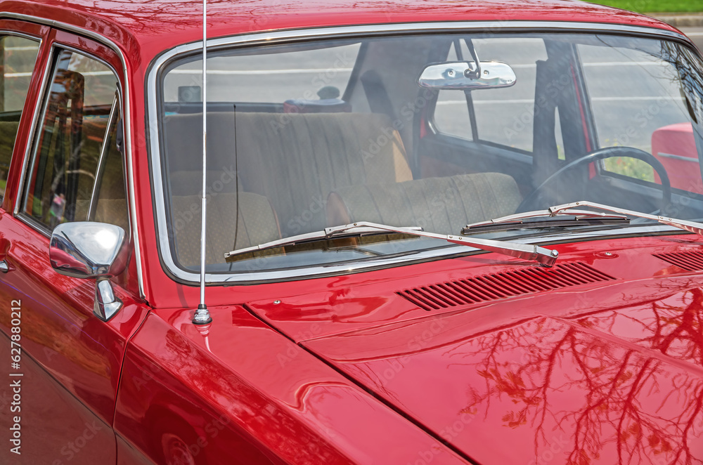 View on interior of retro car through windshield from the side of hood