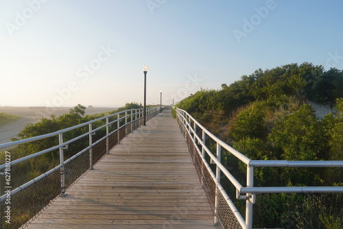 Boardwalk with Historic Lighting and Railings Through Dunes in Summer