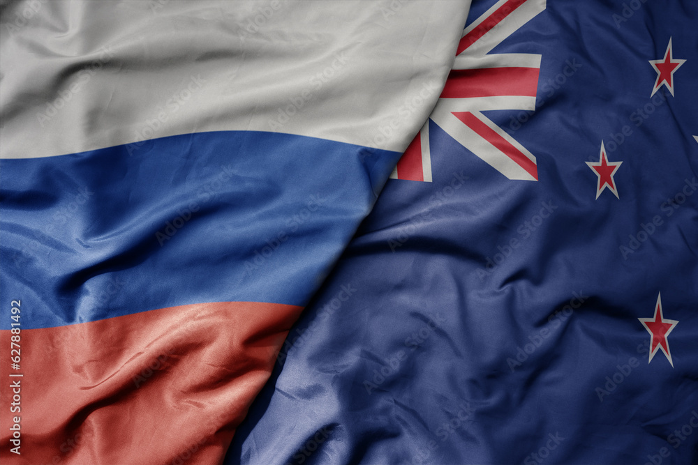 Fototapeta premium big waving realistic national colorful flag of russia and national flag of new zealand .