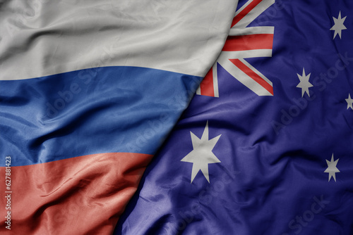 big waving realistic national colorful flag of russia and national flag of australia .