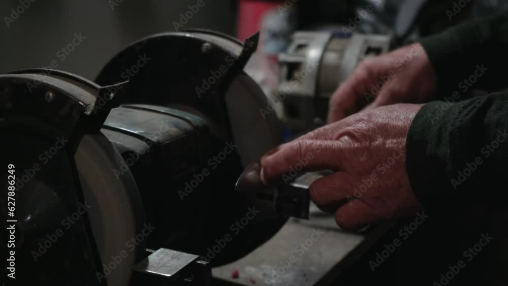 Grinding work with smooth equipment for steel metal, iron. Close-up of sparks in the workshop. Processing tools on a grinding machine. Grinding work with smooth equipment for steel metal, iron. Close-up of sparks in the workshop. Processing tools on a grinding machine.