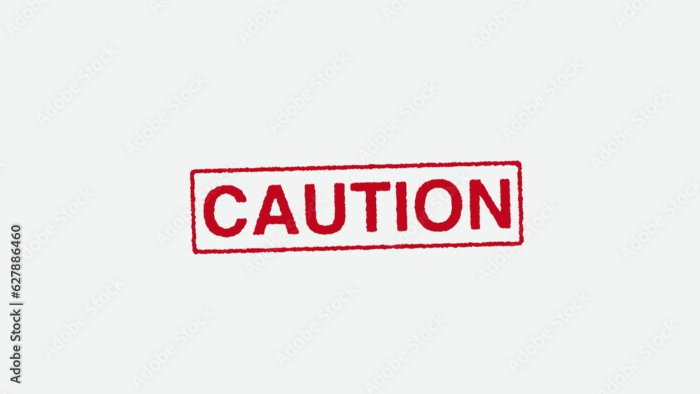Close Up Real Hand Stamping Caution Stamp on White Background Close Up Real Hand Stamping Caution Stamp on White Background