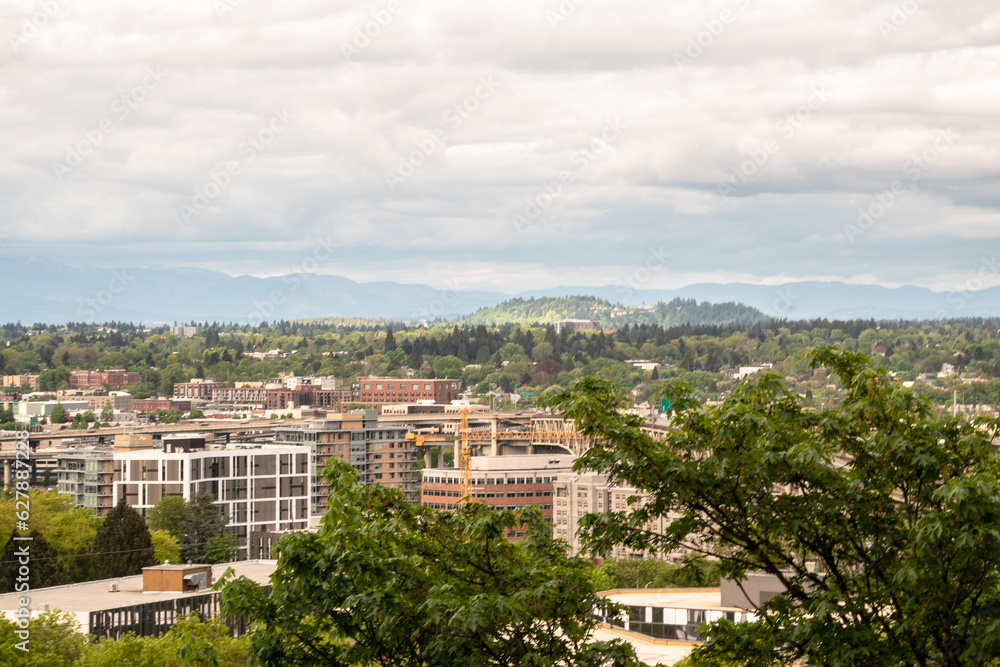 Obraz premium View of Portland, OR Suburb Skyline Houses and Butte on Cloudy Day