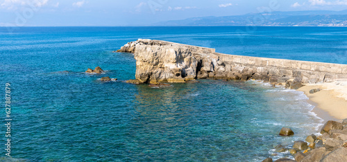 Fototapeta Naklejka Na Ścianę i Meble -  View of coastline in southern Italy. Scenic view from on top cliff looking out to sea. Calabria coastline with eroded cliff on beach
