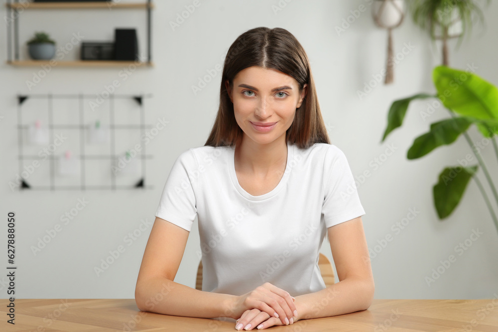 Happy woman having video call at wooden desk indoors, view from web camera Happy woman having video call at wooden desk indoors, view from web camera