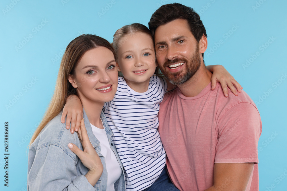 Happy family together on light blue background Happy family together on light blue background