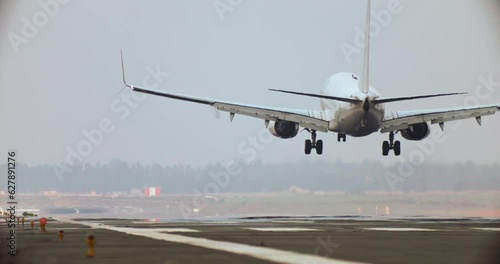 Aviation and air travel passenger plane lands on the runway. Tourists arrived at the airport. High quality 4k footage
