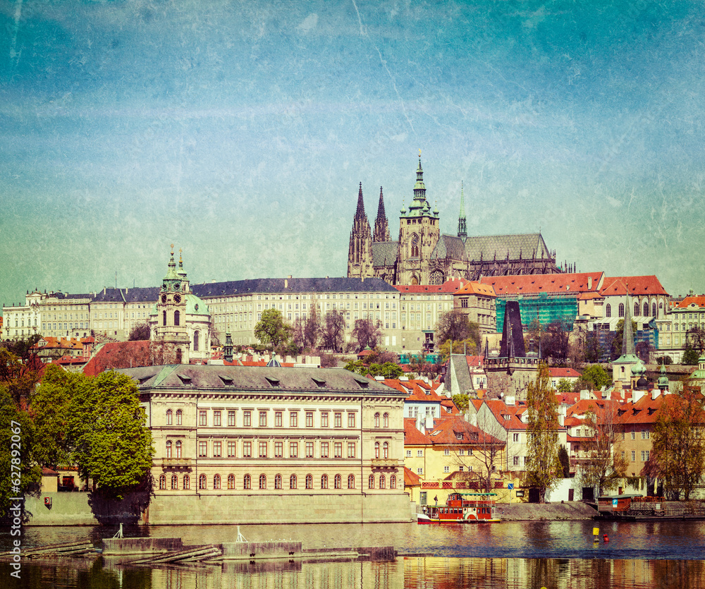 Fototapeta premium Vintage retro hipster style travel image of Charles bridge over Vltava river and Gradchany (Prague Castle) and St. Vitus Cathedral with grunge texture overlaid