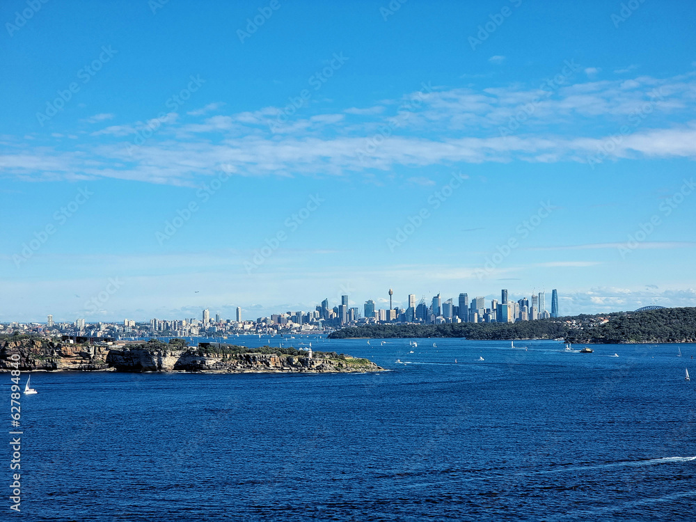 Obraz premium The City of Sydney Australia Viewed From North Head. Looking over Sydney Harbour filled with sailing boats