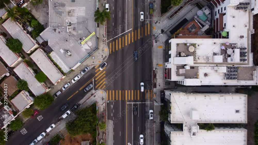 Cars driving at junction with crosswalks in America. Birds eye view drone shot Cars driving at junction with crosswalks in America. Birds eye view drone shot