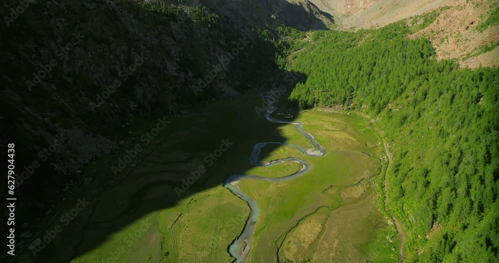 Aerial drone view of Predarossa plain and Duino river flowing in summer season in Val Masino, Italy Aerial drone view of Predarossa plain and Duino river flowing in summer season in Val Masino, Italy