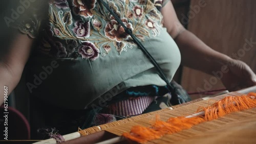 Woman Pulling and Raising Thread in Traditional Weaving Loom San Cristobal de las Casas, Zinacantán, Chiapas, Mexico Closeup photo