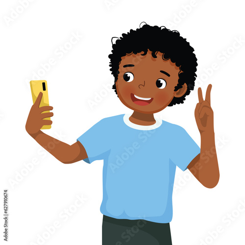 little African boy taking selfie with smartphone making peace sign