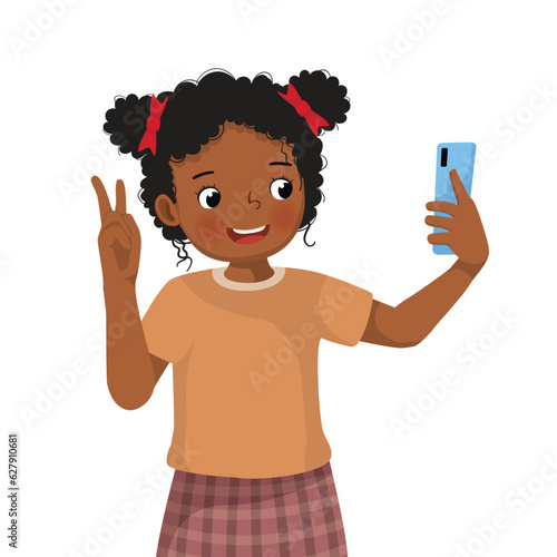 Little African girl taking selfie with smartphone making peace sign