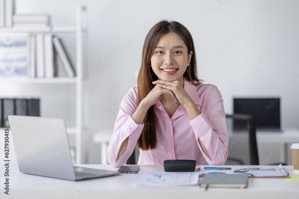 Asian Businesswoman Using laptop computer and working at office with calculator document on desk, doing planning analyzing the financial report, business plan investment, finance analysis concept.
Asian Businesswoman Using laptop computer and working at office with calculator document on desk, doing planning analyzing the financial report, business plan investment, finance analysis concept.