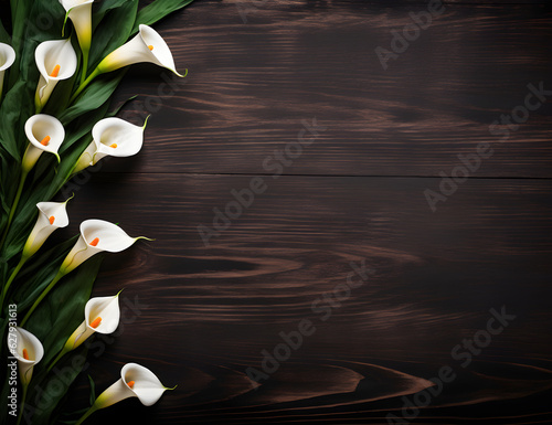 Photographie A Calla Lily Floral Border with Copy Space on a Wood Surface