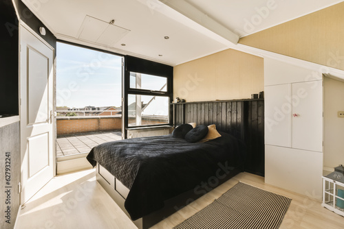 a bedroom with wood flooring and large windows overlooking the cityscapea photo taken from an apartment in new york, ny