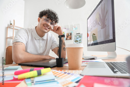 Male graphic designer worki...