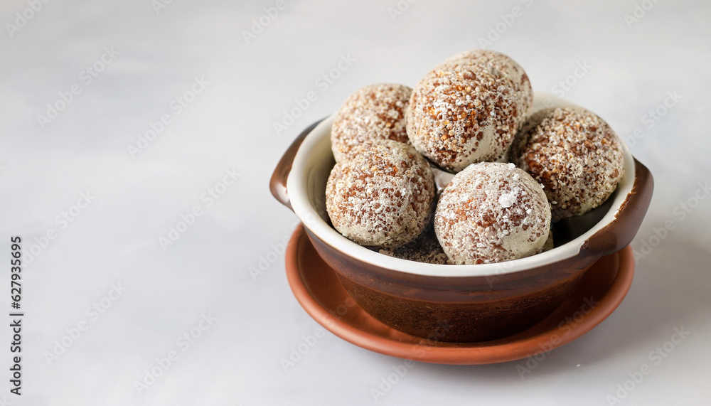 energy balls in a ceramic bowl on a light background, copyspace energy balls in a ceramic bowl on a light background, copyspace