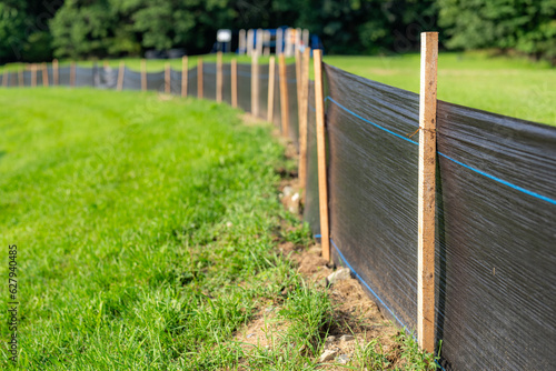 Silt Fence fabric with wooden posts installed prior to the start of construction.
 photo