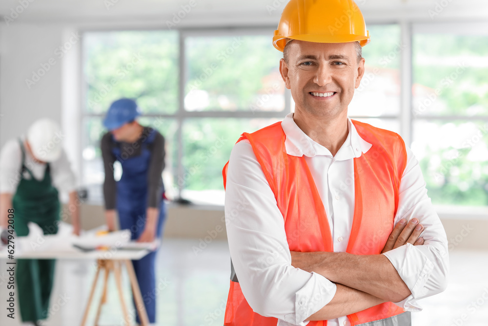 Mature builder working in room Mature builder working in room