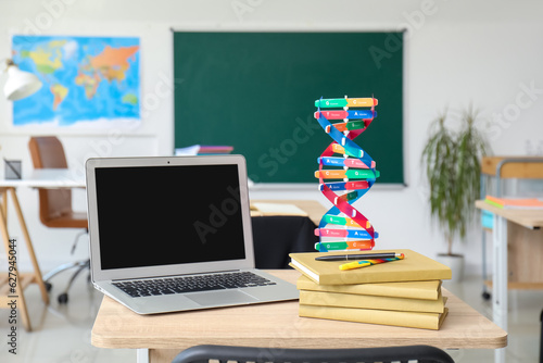 Laptop with books and molec...