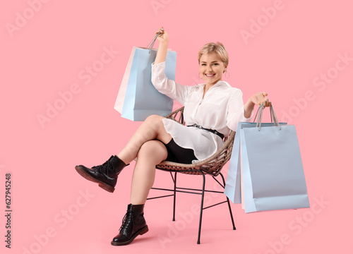 Happy young woman sitting i...
