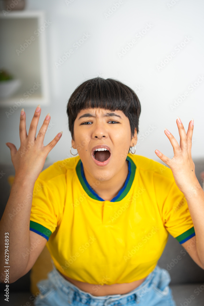 Woman screaming because her team missed a goal, watching a soccer game Woman screaming because her team missed a goal, watching a soccer game