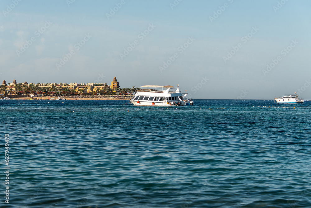Tourist boat silhouetts on the shores of the red sea in Makadi Bay Egypt