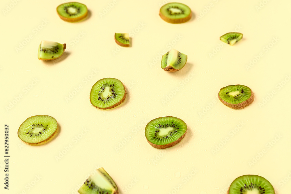 Slices of fresh kiwi on yellow background Slices of fresh kiwi on yellow background