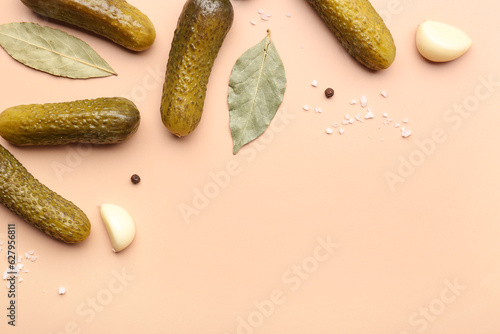 Fototapeta Naklejka Na Ścianę i Meble -  Pickled cucumbers and different spices on orange background
